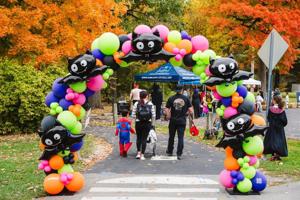 A beautiful Halloween balloon arch with balloon spiders in it.